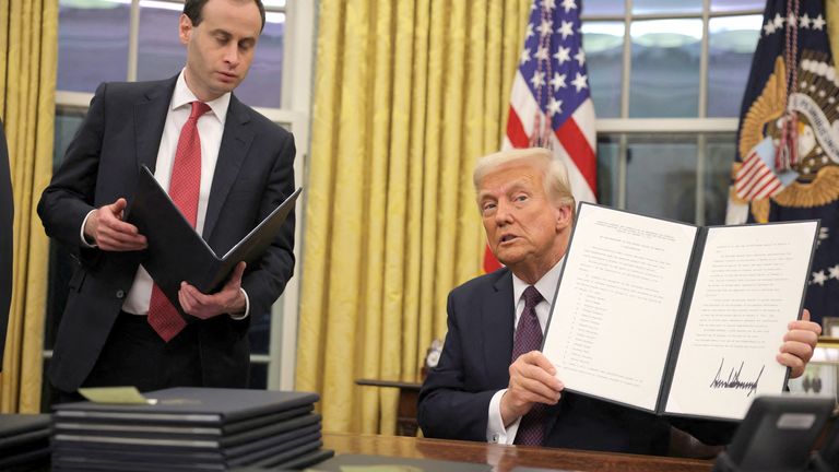 Donald Trump signs pardons for January 6 defendants in the Oval Office.
Pic: Reuters