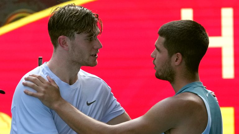 Carlos Alcaraz, right, of Spain is congratulated by Jack Draper of Britain, left after Draper retires from their fourth round match at the Australian Open tennis championship in Melbourne, Australia, Sunday, Jan. 19, 2025. (AP Photo/Mark Baker)