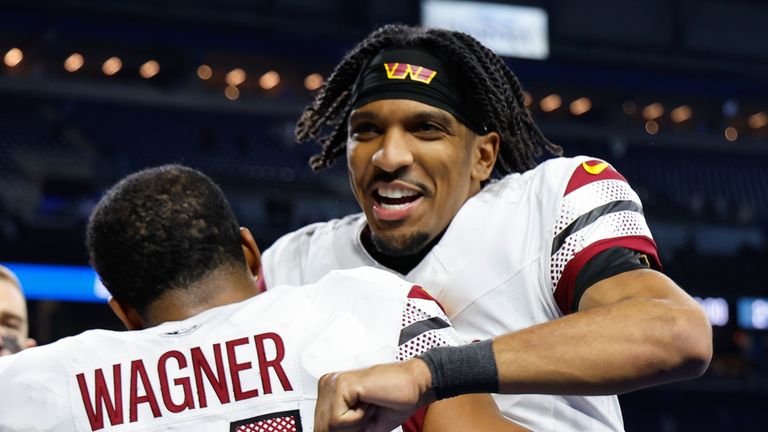 Washington Commanders quarterback Jayden Daniels celebrates with Bobby Wagner (54) after winning against Detroit Lions